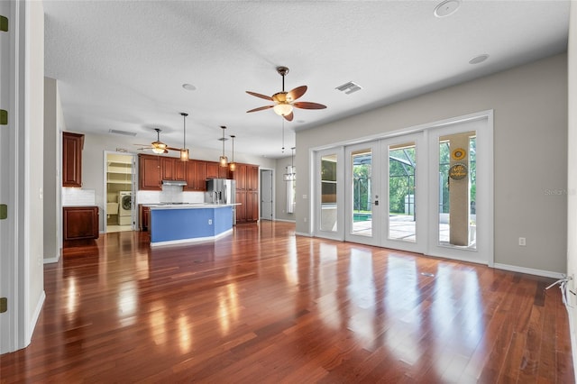 1711 145th St E, Sarasota, FL 34212 - unfurnished living room featuring a ceiling fan, dark wood-style flooring, and a textured ceiling