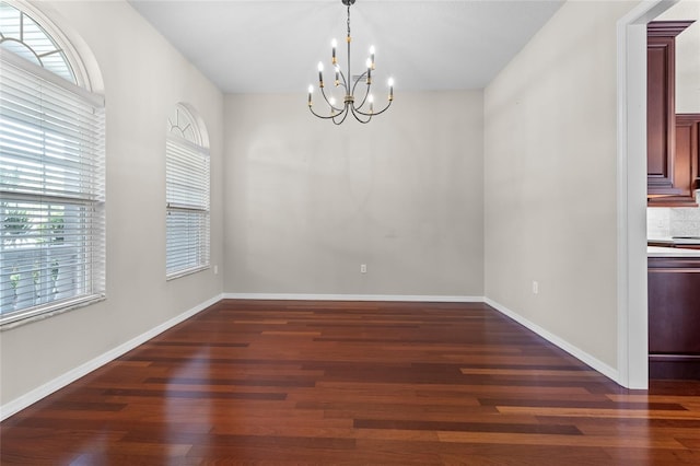 1711 145th St E, Sarasota, FL 34212 - unfurnished dining area featuring a chandelier and dark wood-style flooring