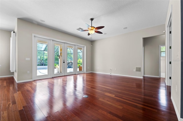 1711 145th St E, Sarasota, FL 34212 - empty room featuring healthy amount of natural light, ceiling fan, wood finished floors, and a textured ceiling