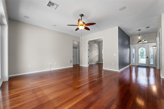 1711 145th St E, Sarasota, FL 34212 - unfurnished living room featuring a ceiling fan, wood finished floors, and a textured ceiling