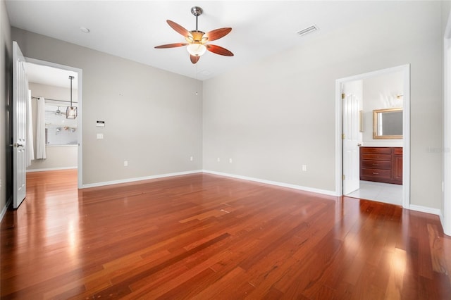 1711 145th St E, Sarasota, FL 34212 - unfurnished bedroom with light wood finished floors, connected bathroom, and ceiling fan