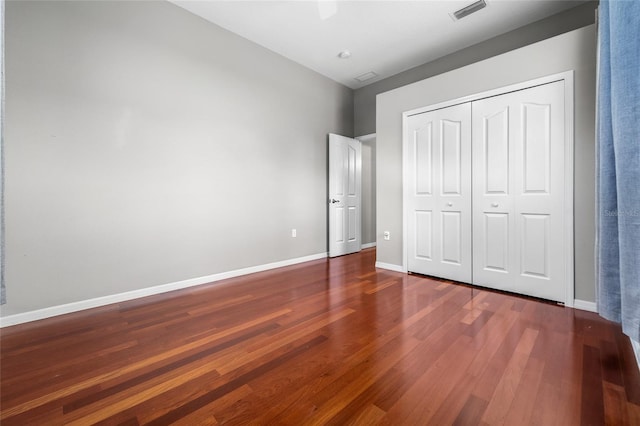 1711 145th St E, Sarasota, FL 34212 - unfurnished bedroom featuring wood finished floors, a closet, and ceiling fan
