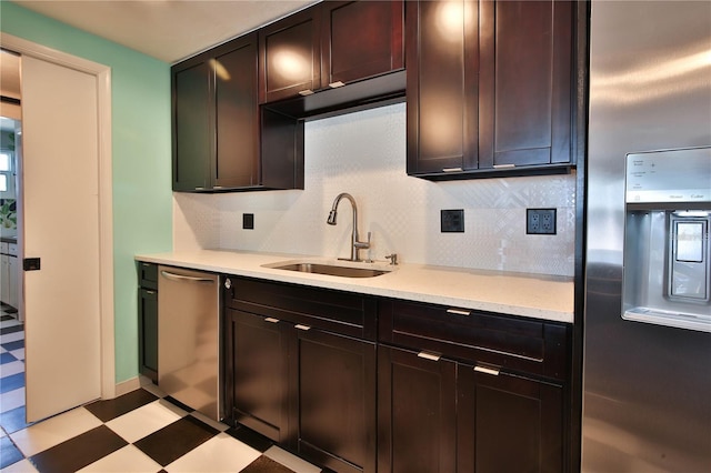 7355 Cass Cir, Sarasota, FL 34231 - kitchen featuring appliances with stainless steel finishes, light floors, backsplash, and dark brown cabinetry