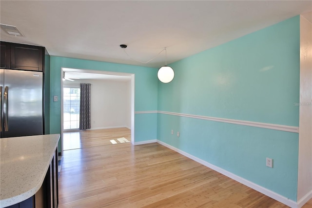 7355 Cass Cir, Sarasota, FL 34231 - unfurnished dining area featuring baseboards and light wood finished floors