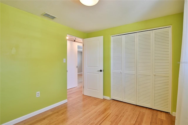 7355 Cass Cir, Sarasota, FL 34231 - unfurnished bedroom featuring light wood-style floors and a closet