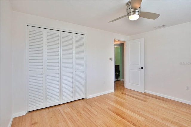 7355 Cass Cir, Sarasota, FL 34231 - unfurnished bedroom featuring light wood-style flooring, a closet, and ceiling fan