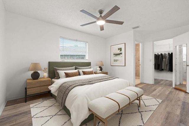 5433 81st Avenue Cir E, Palmetto, FL 34221 - bedroom with a closet, light wood-style flooring, baseboards, and a walk in closet