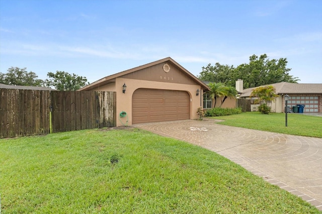 5433 81st Avenue Cir E, Palmetto, FL 34221 - view of front of house with an attached garage, decorative driveway, a chimney, and stucco siding