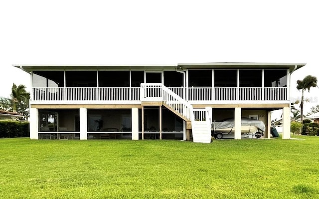 5111 Bay State Rd, Palmetto, FL 34221 - back of property with a sunroom, a lawn, and stairway