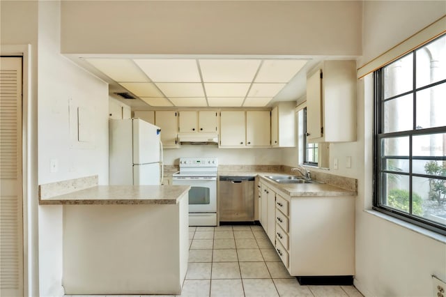 2727 75th St W Unit 1Af, Bradenton, FL 34209 - kitchen with white appliances, under cabinet range hood, light countertops, light tile patterned floors, and a drop ceiling