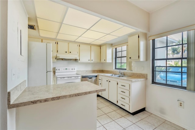 2727 75th St W Unit 1Af, Bradenton, FL 34209 - kitchen featuring white appliances, under cabinet range hood, light tile patterned floors, and light countertops