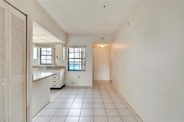 2727 75th St W Unit 1Af, Bradenton, FL 34209 - kitchen featuring light countertops, white cabinetry, and light tile patterned floors