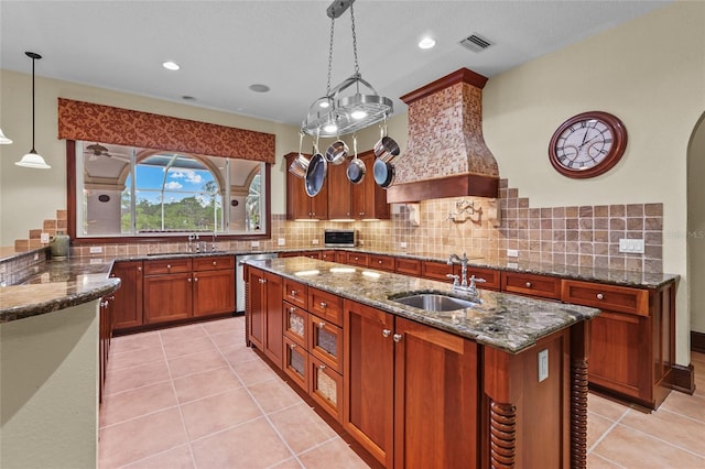7025 Saddle Creek Cir, Sarasota, FL 34241 - kitchen featuring stainless steel dishwasher, dark stone countertops, backsplash, brown cabinets, and recessed lighting