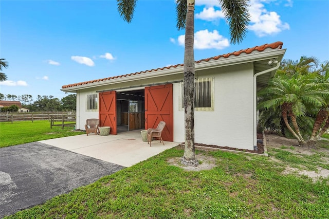 7025 Saddle Creek Cir, Sarasota, FL 34241 - rear view of house featuring a tiled roof, stucco siding, and a patio area