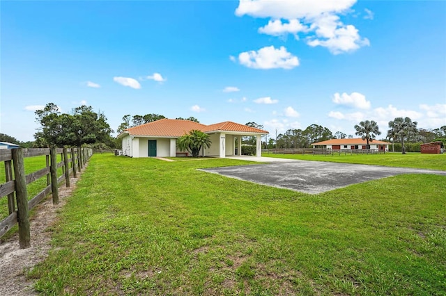 7025 Saddle Creek Cir, Sarasota, FL 34241 - rear view of property with a tiled roof, driveway, stucco siding, and a carport