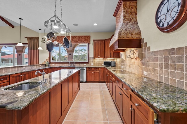 7025 Saddle Creek Cir, Sarasota, FL 34241 - kitchen with stainless steel appliances, custom range hood, tasteful backsplash, brown cabinetry, and dark stone countertops
