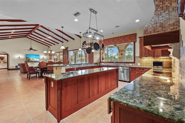 7025 Saddle Creek Cir, Sarasota, FL 34241 - kitchen featuring appliances with stainless steel finishes, backsplash, a ceiling fan, dark stone counters, and hanging light fixtures