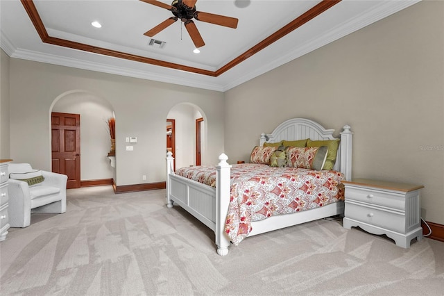 7025 Saddle Creek Cir, Sarasota, FL 34241 - carpeted bedroom with arched walkways, a tray ceiling, ornamental molding, recessed lighting, and a ceiling fan