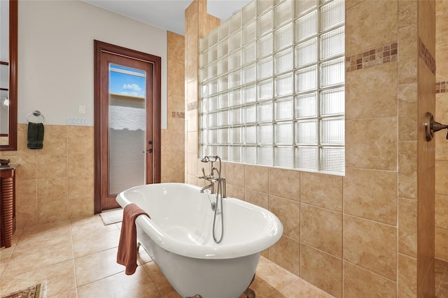 7025 Saddle Creek Cir, Sarasota, FL 34241 - bathroom with tile walls, a freestanding bath, tile patterned floors, and vanity