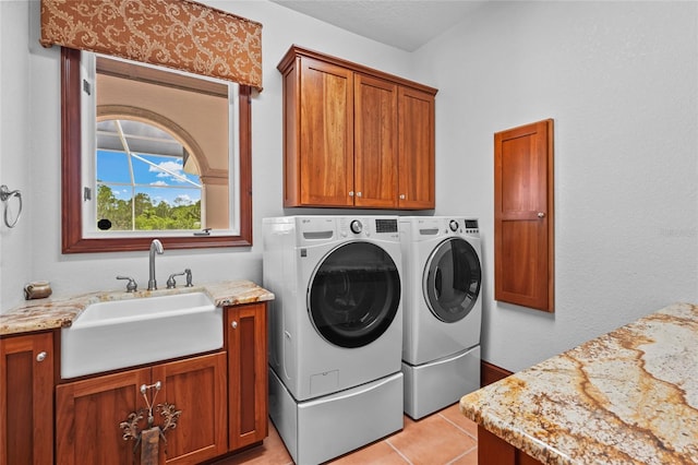 7025 Saddle Creek Cir, Sarasota, FL 34241 - washroom featuring cabinet space, washing machine and clothes dryer, and light tile patterned floors