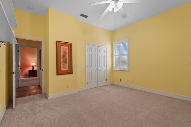7025 Saddle Creek Cir, Sarasota, FL 34241 - unfurnished bedroom featuring light carpet, a closet, and a ceiling fan