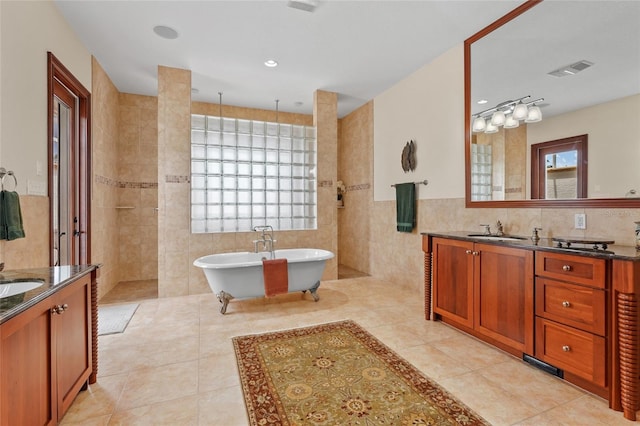 7025 Saddle Creek Cir, Sarasota, FL 34241 - bathroom with tile walls, vanity, a freestanding tub, a walk in shower, and tile patterned floors