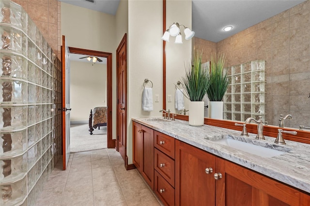 7025 Saddle Creek Cir, Sarasota, FL 34241 - ensuite bathroom with double vanity, ceiling fan, and tile patterned floors