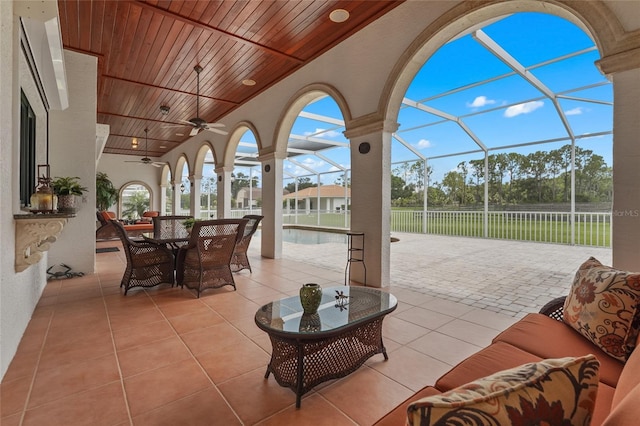 7025 Saddle Creek Cir, Sarasota, FL 34241 - view of patio / terrace with ceiling fan, an outdoor living space, outdoor dining space, a lanai, and an outdoor pool