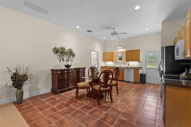 7025 Saddle Creek Cir, Sarasota, FL 34241 - dining space with a ceiling fan, dark tile patterned floors, and recessed lighting
