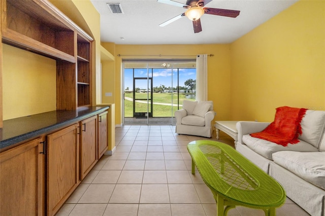 5609 Spanish Point Ct, Palmetto, FL 34221 - living room featuring light tile patterned floors, ceiling fan, and baseboards