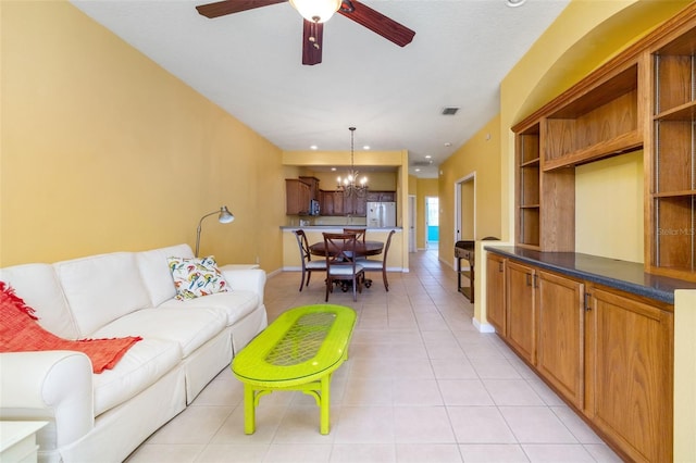 5609 Spanish Point Ct, Palmetto, FL 34221 - living room featuring a chandelier, ceiling fan, light tile patterned flooring, and baseboards