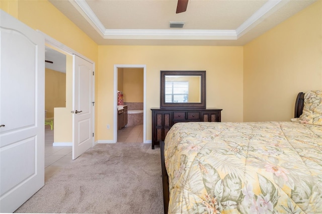 5609 Spanish Point Ct, Palmetto, FL 34221 - bedroom featuring ornamental molding, light carpet, light tile patterned floors, a raised ceiling, and ensuite bathroom