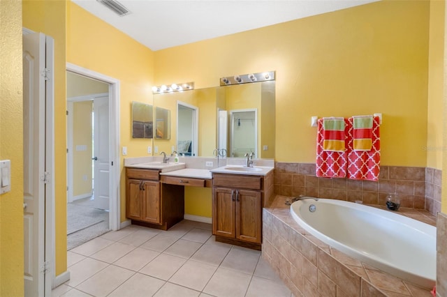 5609 Spanish Point Ct, Palmetto, FL 34221 - bathroom with a bath, double vanity, and tile patterned floors