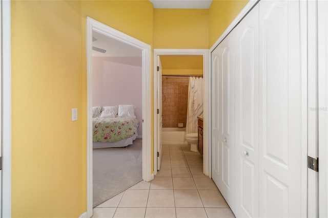 5609 Spanish Point Ct, Palmetto, FL 34221 - corridor featuring light tile patterned flooring and light carpet