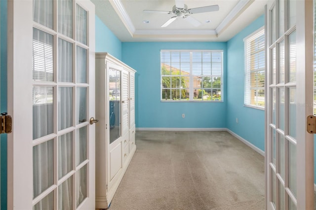 5609 Spanish Point Ct, Palmetto, FL 34221 - carpeted spare room with french doors, a raised ceiling, a ceiling fan, baseboards, and crown molding