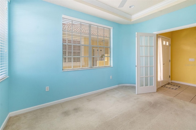 5609 Spanish Point Ct, Palmetto, FL 34221 - carpeted spare room with crown molding, baseboards, a ceiling fan, and tile patterned flooring