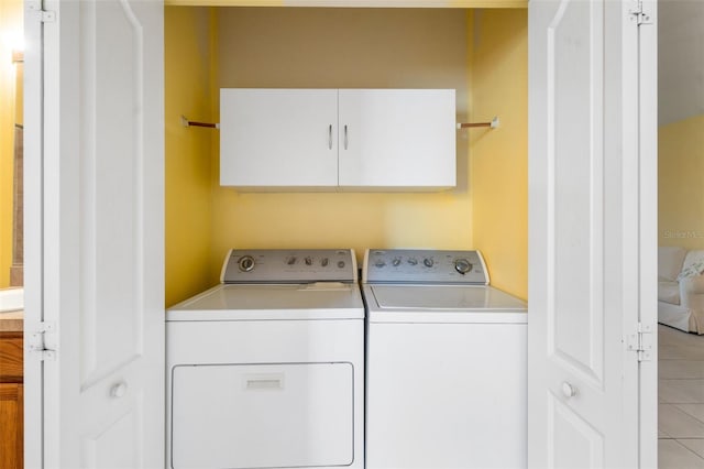 5609 Spanish Point Ct, Palmetto, FL 34221 - washroom with independent washer and dryer, cabinet space, and light tile patterned flooring