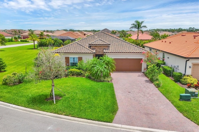 4524 Baltry Ct, Bradenton, FL 34211 - mediterranean / spanish home with a tiled roof, a garage, decorative driveway, and a front lawn