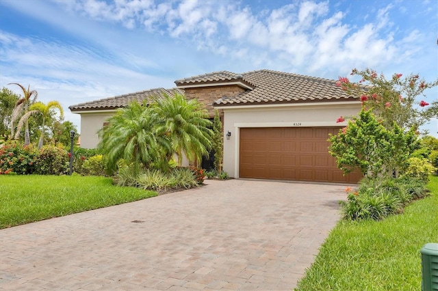 4524 Baltry Ct, Bradenton, FL 34211 - mediterranean / spanish-style house with stucco siding, driveway, a garage, a tile roof, and a front yard