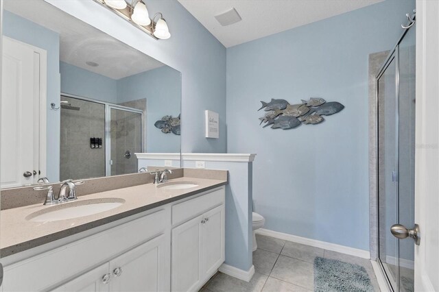 4524 Baltry Ct, Bradenton, FL 34211 - bathroom featuring toilet, a stall shower, tile patterned floors, and double vanity