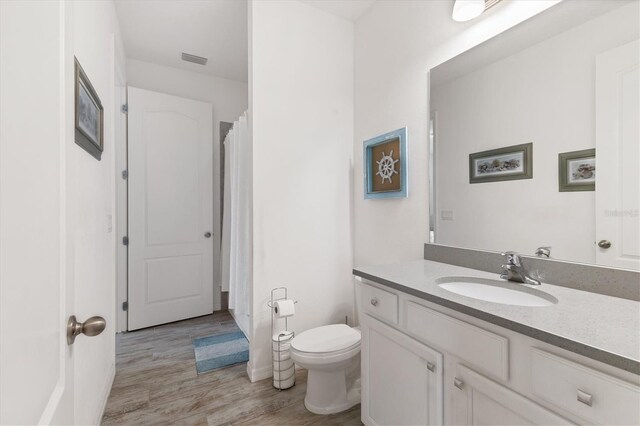4524 Baltry Ct, Bradenton, FL 34211 - bathroom featuring vanity, toilet, wood finished floors, and a shower with shower curtain