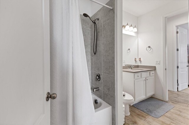 4524 Baltry Ct, Bradenton, FL 34211 - bathroom with vanity, shower / bath combination with curtain, wood finished floors, toilet, and baseboards