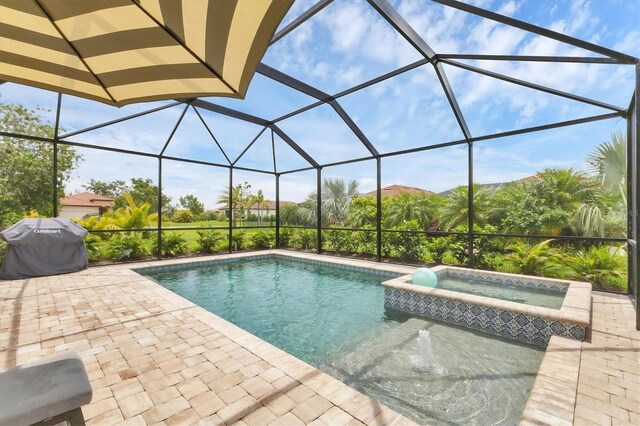 4524 Baltry Ct, Bradenton, FL 34211 - view of pool featuring a pool with connected hot tub, a patio, glass enclosure, and area for grilling