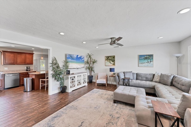 7727 9th Avenue Dr NW, Bradenton, FL 34209 - living room with recessed lighting, dark wood-style floors, ceiling fan, a textured ceiling, and baseboards
