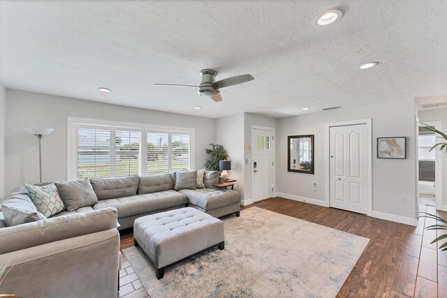 7727 9th Avenue Dr NW, Bradenton, FL 34209 - living room featuring ceiling fan, dark wood-style flooring, baseboards, recessed lighting, and a textured ceiling