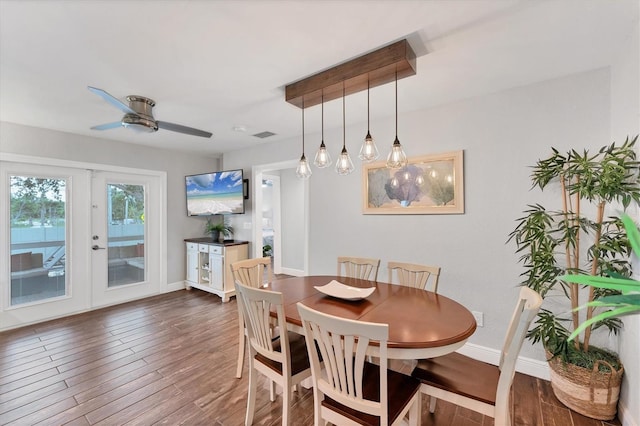 7727 9th Avenue Dr NW, Bradenton, FL 34209 - dining area with dark wood-type flooring, a ceiling fan, baseboards, and french doors