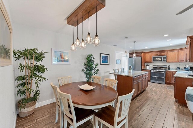 7727 9th Avenue Dr NW, Bradenton, FL 34209 - dining space with light wood-style flooring, baseboards, and recessed lighting
