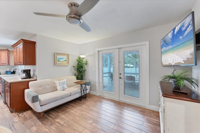7727 9th Avenue Dr NW, Bradenton, FL 34209 - living room with french doors, light wood-type flooring, a ceiling fan, and baseboards