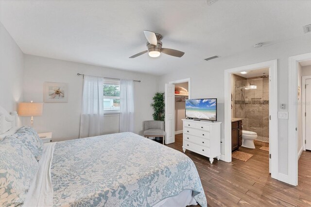 7727 9th Avenue Dr NW, Bradenton, FL 34209 - bedroom featuring a spacious closet, dark wood-style floors, baseboards, and a ceiling fan