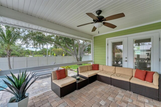7727 9th Avenue Dr NW, Bradenton, FL 34209 - fenced backyard with an outdoor living space, french doors, a patio, and ceiling fan